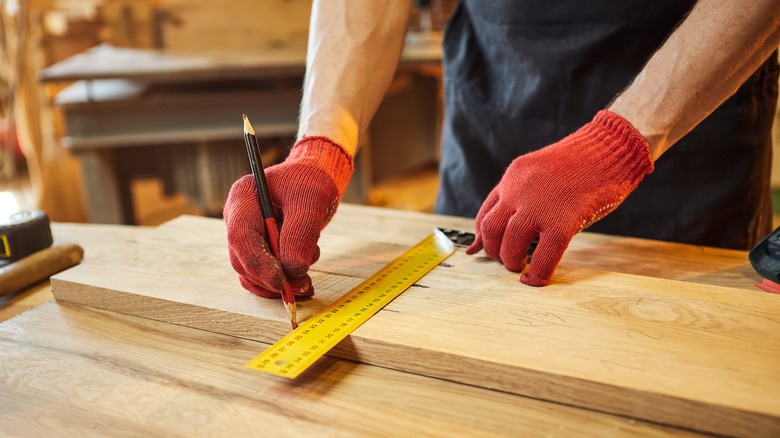 carpenter measuring wood