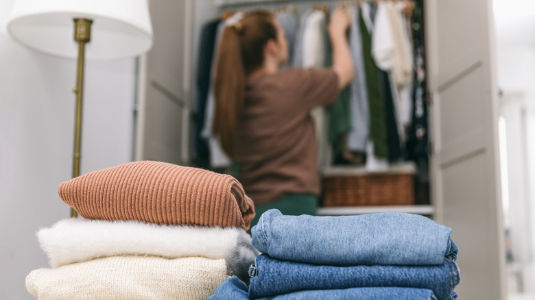 Woman cleaning out and organizing her closet.