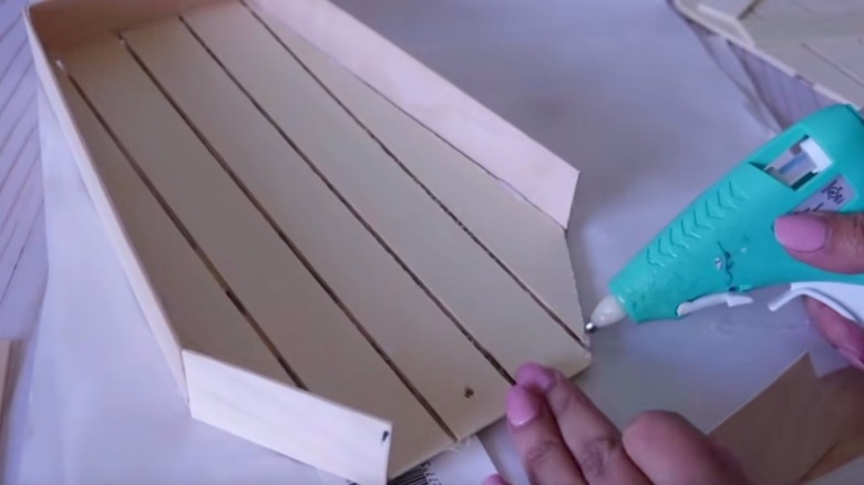 The DIY coffin with a plastic skeleton hand inside