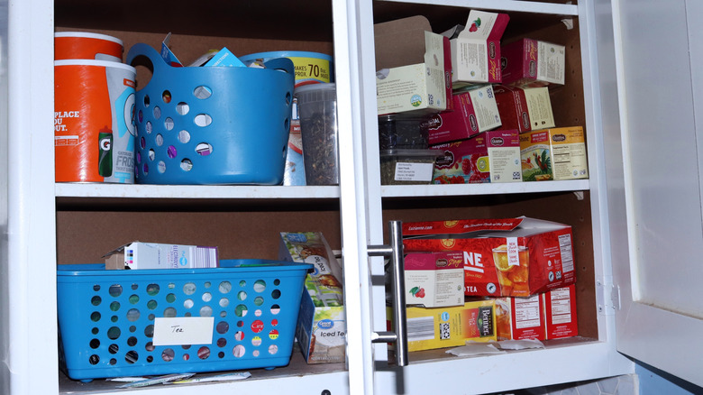 A cluttered kitchen cabinet