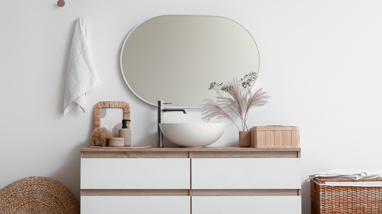 Organized bathroom vanity with mirror.