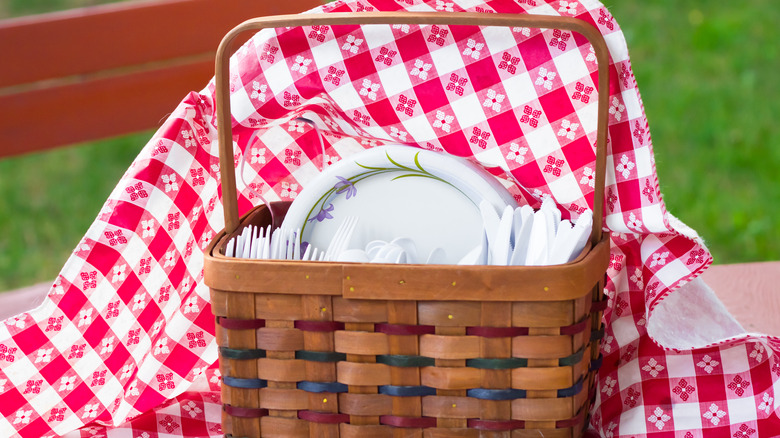 picnic basket with tablecloth flying up