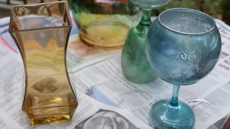 Mercury glass looking fish bowl on a glass flute on a newspaper