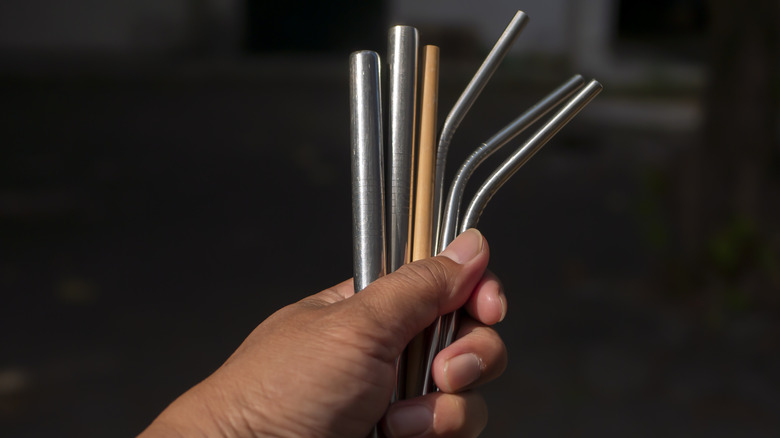 Someone holding reusable straws