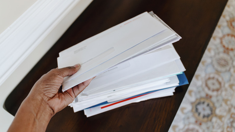 Hand holding a stack of mail