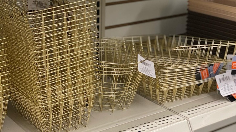 A stack of gold wire baskets on a Dollar Tree shelf