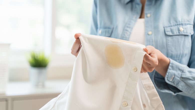 Person holding up piece of stained laundry