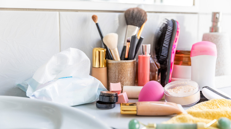 Bathroom counter with lots of items on it