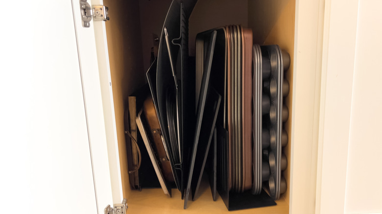 Baking sheets and supplies tucked in a cabinet