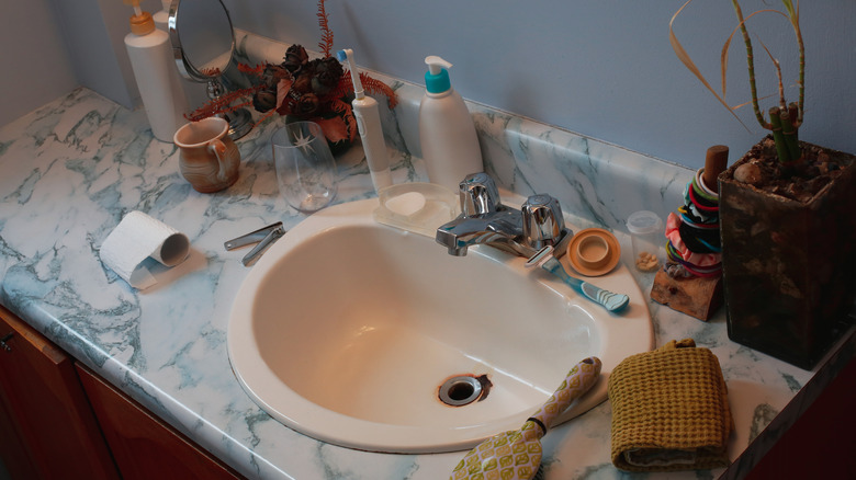 Cluttered marble bathroom countertop
