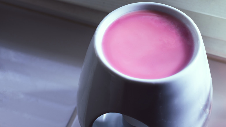 Melted pink wax inside a wax warmer