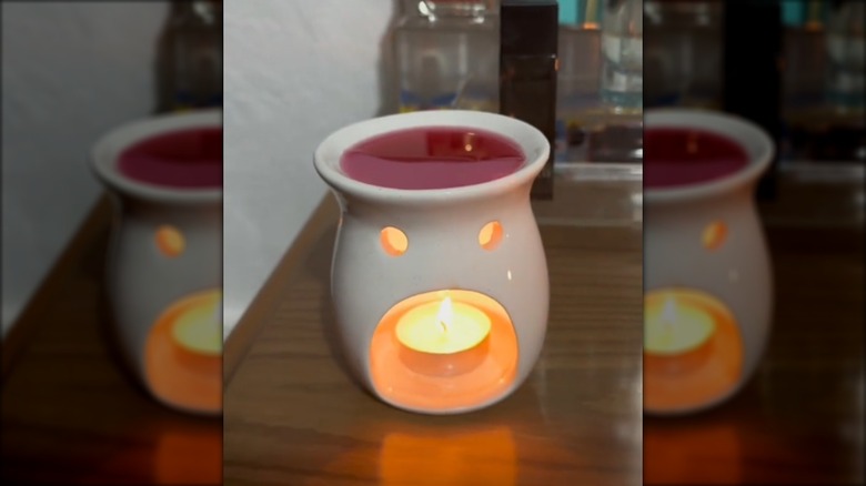 The wax warmer from Dollar Tree with a pink wax melt.