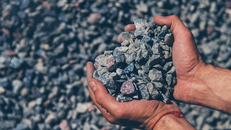 Hands holding gravel