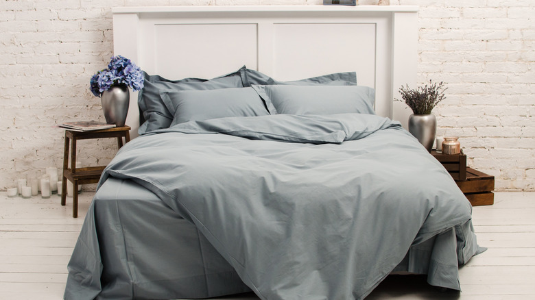 Bed with all gray sheets, blankets, and pillows