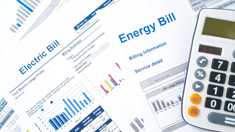 A printed utility bill with a calculator next to it