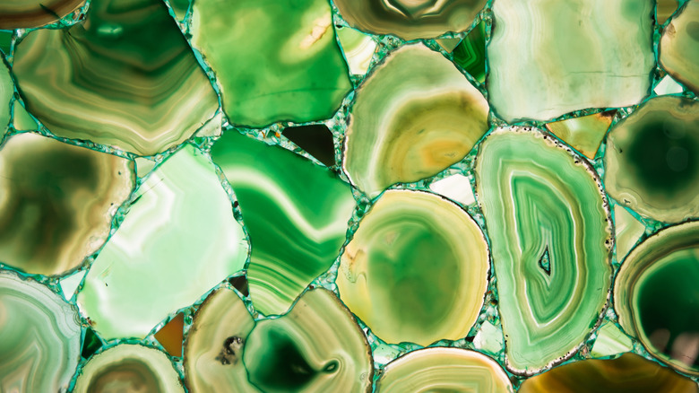 A closeup of green banded slices of agate
