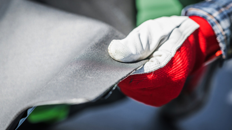 A worker holding EPDM roofing material