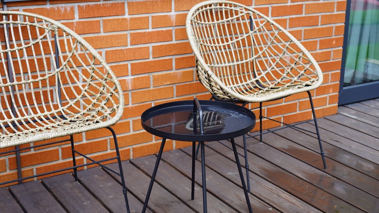 Wicker chairs on a wet deck