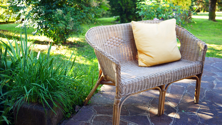 A woman sitting in a wicker chair