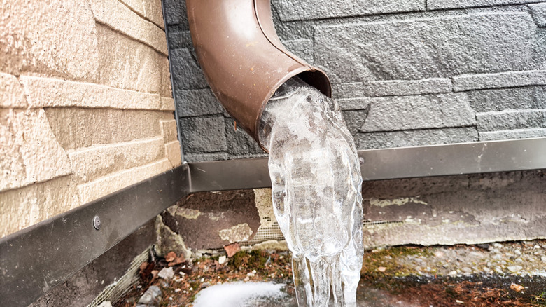 Block of ice sticking out of downspout