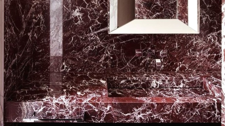 Red marble tiles used around the vanity in a bathroom
