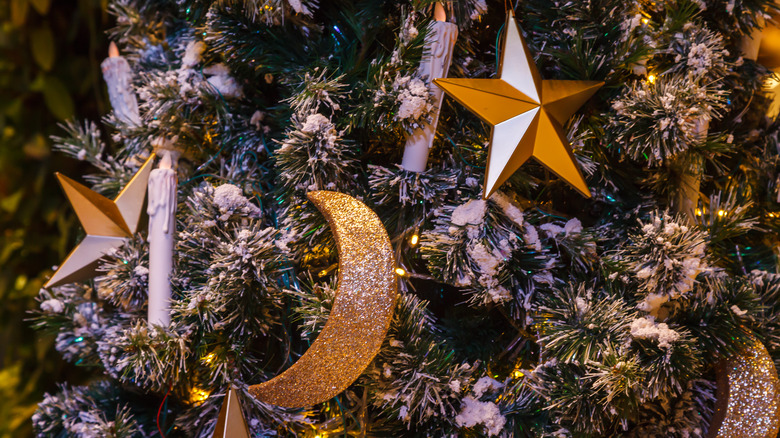 Star and moon ornaments on Christmas tree