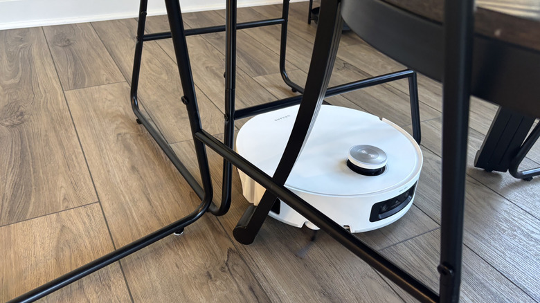Dreame Aqua10 Ultra Roller vacuuming between stools and table legs