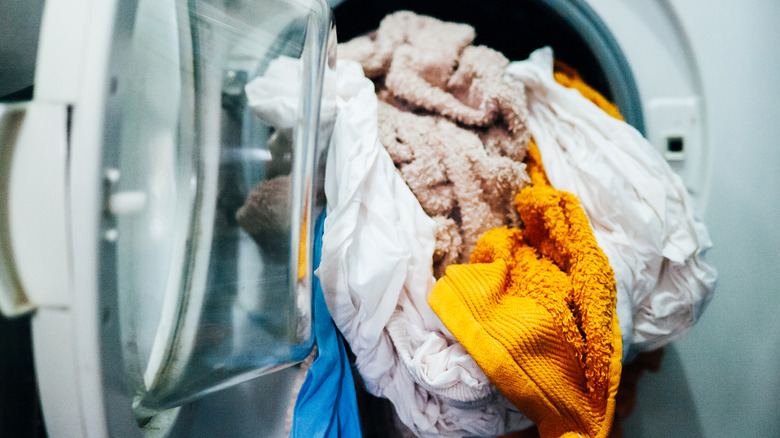 An overfilled dryer with bunched up laundry