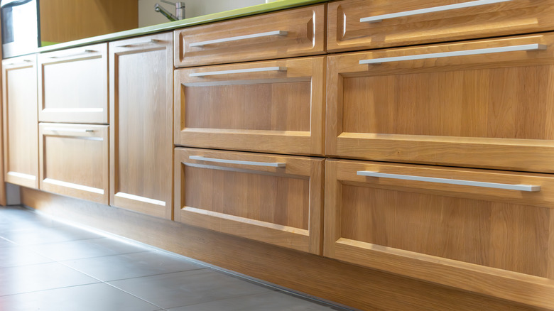 A row of wooden kitchen cabinets