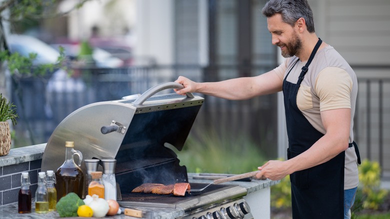 Man grilling in outdoor kitchen