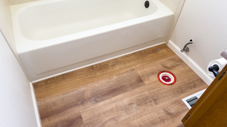 bathroom under construction with vinyl floor tile
