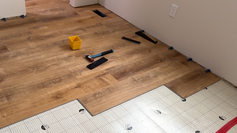 Partially finished installation of luxury plank vinyl tiles