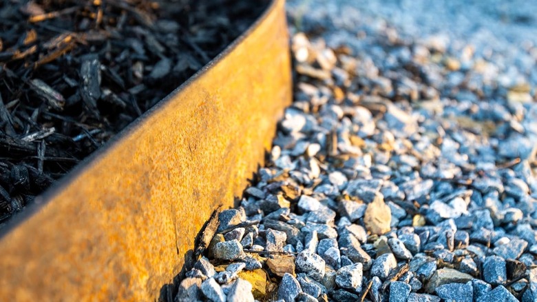 Hammer-in metal edging creates a solid barrier between grass and the driveway