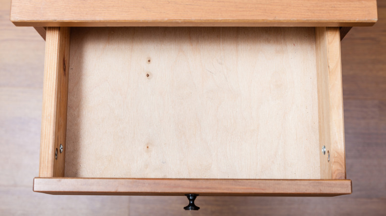 An empty dresser drawer is shown from a birds-eye view