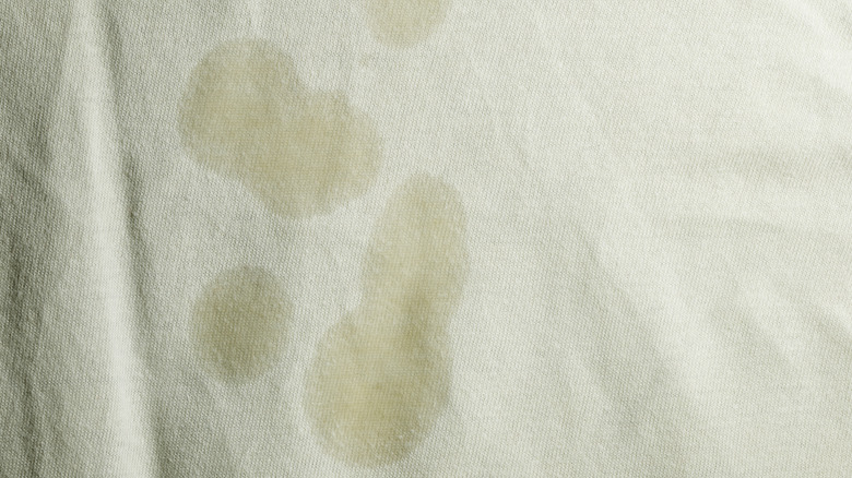 Close-up of oil stains on white cloth