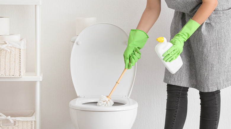 Cleaning toilet with toilet brush