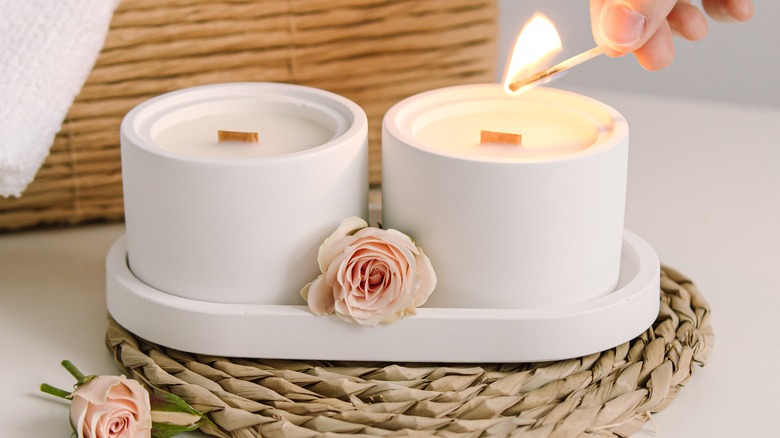 hand lighting concrete candle