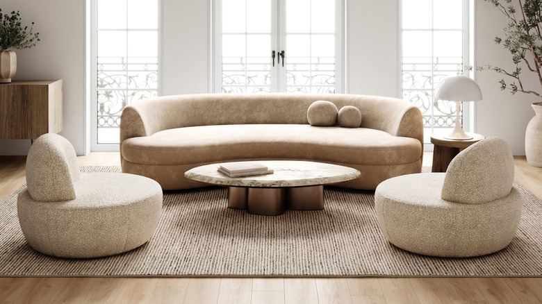 A living room with many curved furniture pieces and elements