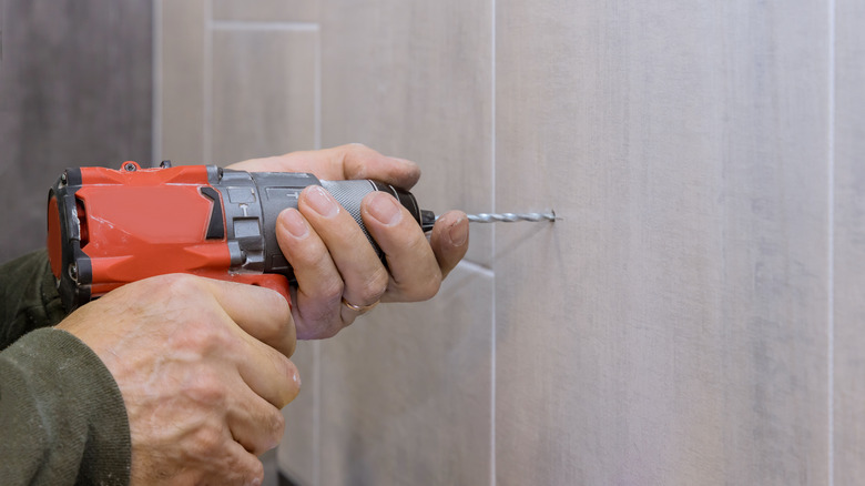 man drilling a hole