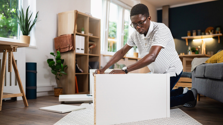 Man assembling bookcase