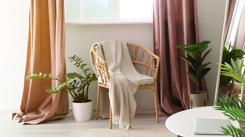 woman with floor length curtains