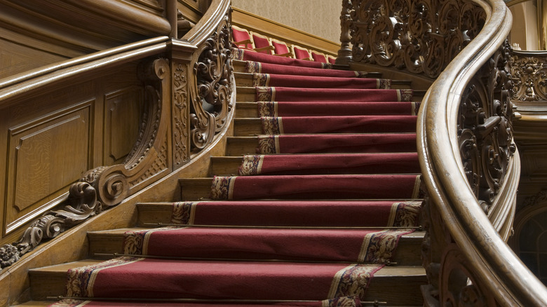 Large wooden staircase with runner