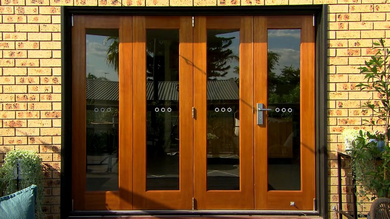 Wooden bifold doors, brick wall 