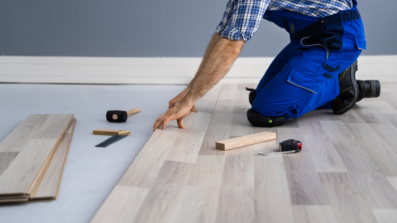 Person installing laminate flooring