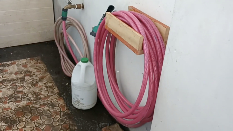 A hose holder made from recycled pallet wood