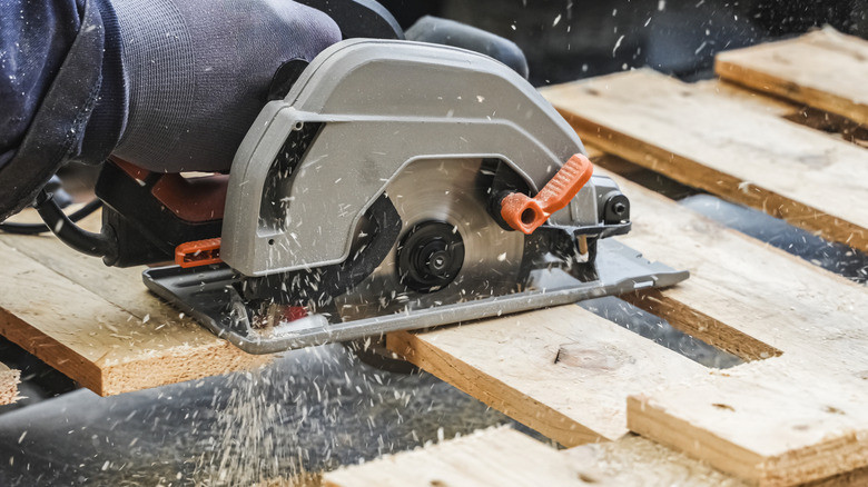 Cutting through a wood pallet with a circular saw