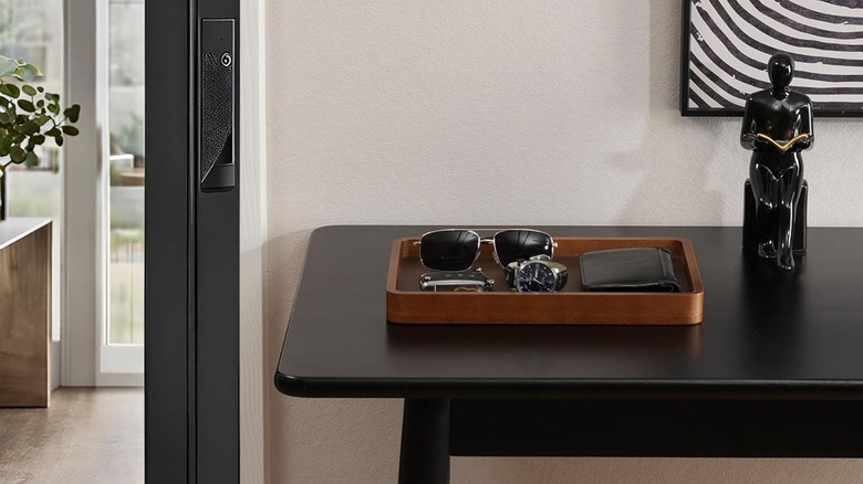 catchall tray near door holding wallet, glasses, and more