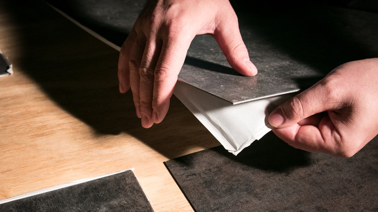 Person holding vinyl tile