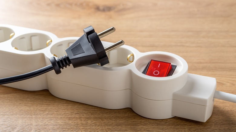 Plug lying atop a power strip