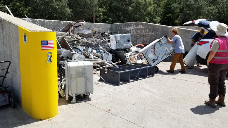 People taking trash to landfill